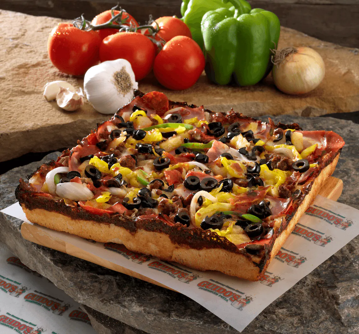 Guido's Detroit-style deep dish, cut in squares with sauce on top